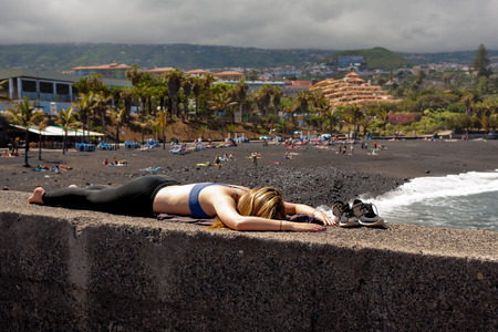 Young girl is resting on the beach. Tenerife island.の写真素材