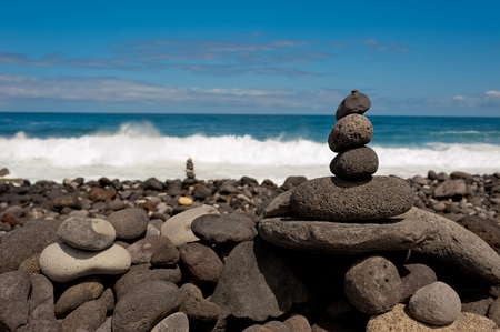 Stack of stones on the sea beach. Tenerife island.の写真素材