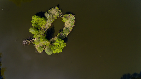 Aerial view of the small island in the city lake. Top view.の写真素材