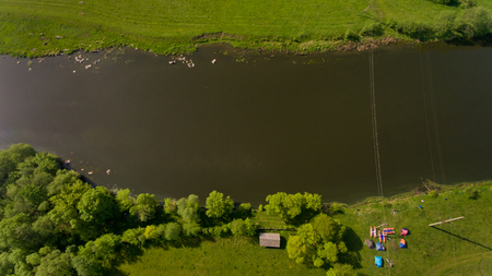 Top view of camp of tourists with tents on the river bank.の写真素材