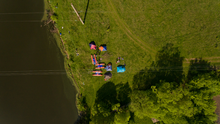Top view of camp of tourists with tents on the river bank.の写真素材