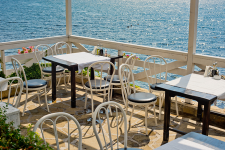 A table in the summer empty cafe by the sea.の写真素材