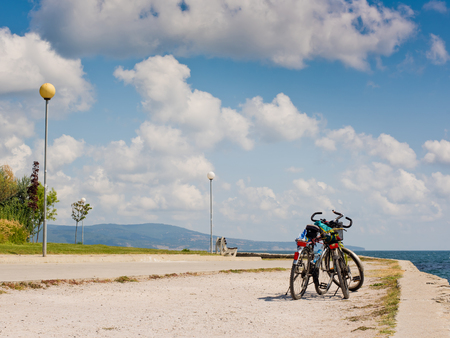 Two bicycles on the background of the sea and sky with clouds.の写真素材