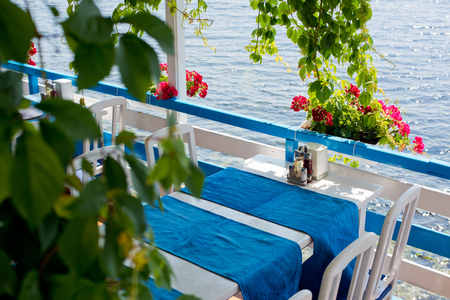 A table in the summer empty cafe by the sea.の写真素材