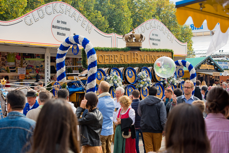 Munich, Germany - October 07, 2018: people and fairground rides at the biggest folk festival in the world - the oktoberfest.のeditorial素材