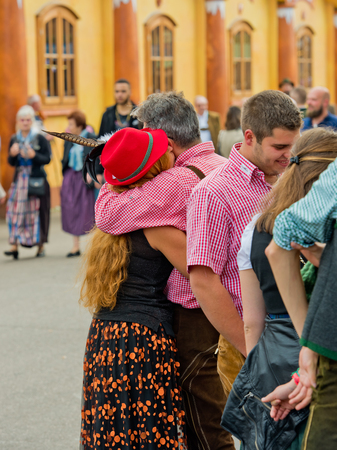 Munich, Germany - October 07, 2018: Guy and girl in national costume hug at the biggest folk festival in the world - the oktoberfest.のeditorial素材