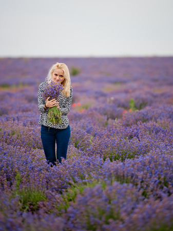 Soft focus flowers, beautiful lavender flowers blooming. Cute girl with a bouquet of lavender flowers.の写真素材