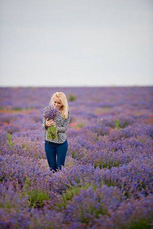 Soft focus flowers, beautiful lavender flowers blooming. Cute girl with a bouquet of lavender flowers.の写真素材