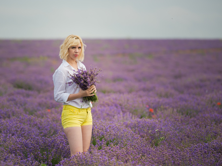 Young girl posing in a lavender field.の写真素材