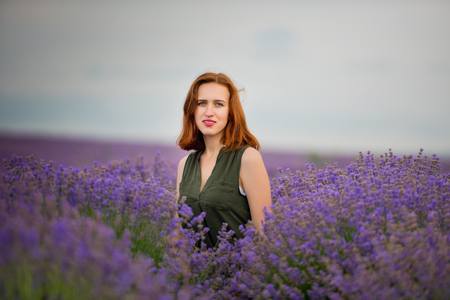 Young girl with, posing in a lavender field.の写真素材
