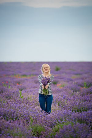 Soft focus flowers, beautiful lavender flowers blooming. Cute girl with a bouquet of lavender flowers.の写真素材