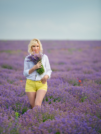 Young girl posing in a lavender field.の写真素材