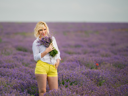 Young girl posing in a lavender field.の写真素材