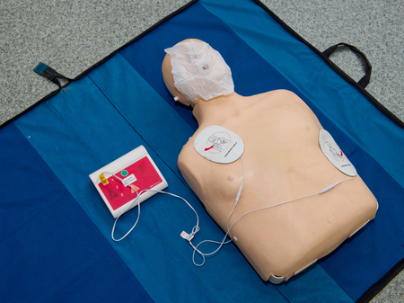 Automated external defibrillator with training dummy mannequin.