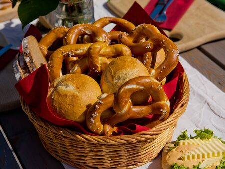 Buns and pretzels. Basket with bread rolls and pretzels on an table.