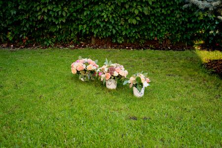 Three bridal bouquets on the green grass.の写真素材