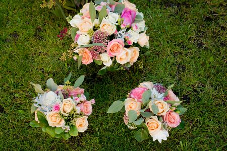 Three wedding bouquets on the green grass. Top view.の写真素材
