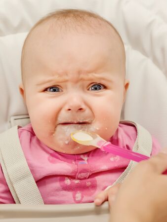 Baby refuse to eat a porridge.の写真素材