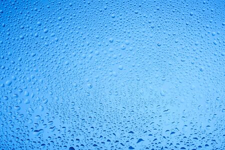 Blue water drops on glass. Background.の写真素材