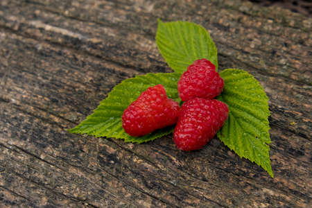 Ripe aromatic raspberries on a wooden background.の写真素材