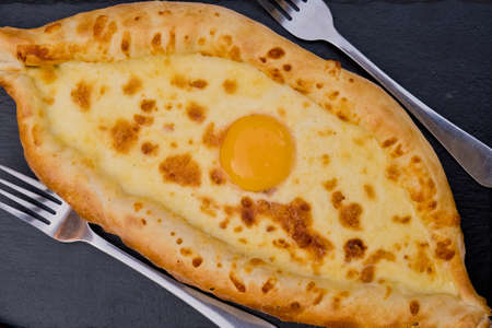 Georgian dish khachapuri with egg in the center. Soft focus. Closeup. Top view.の写真素材