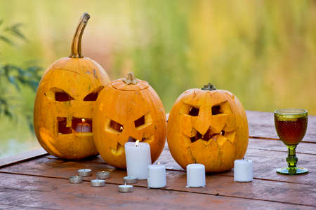 Many pumpkins Jack lantern on wooden background for Halloween party. Selective focus.の写真素材