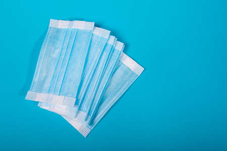 Medical mask on a blue background with copy space.の写真素材