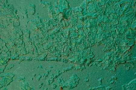 Old green paint on metal board. Texture for backdrop. Close up.