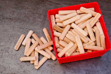 View of a grouping of wooden dowels on gray background. close-up.