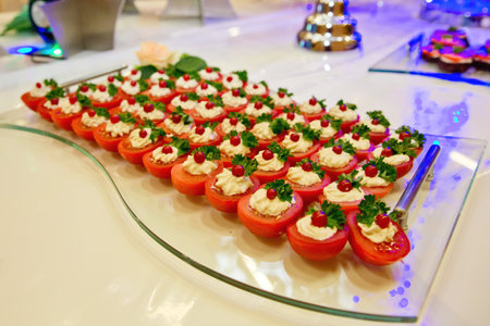 European buffet catering food. Tomato halves with cream cheese. Celebration party concept. selective focus.の写真素材
