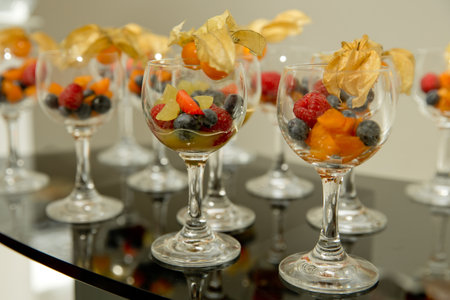 A lot of wine glasses with fresh fruit on the table at the ceremony. selective focus.の写真素材
