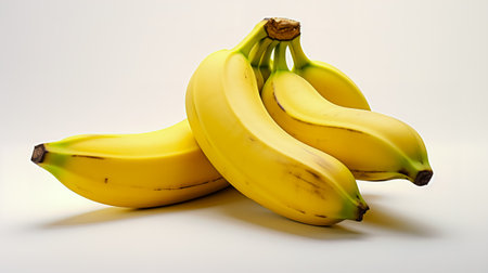 Bunches of bananas sitting next to each other on white surface.の素材