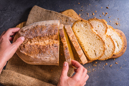 Fresh bread and hands top view.