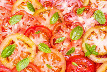 Tomatoes background.Slices of red and yellow tomatoes.Red food background.の写真素材