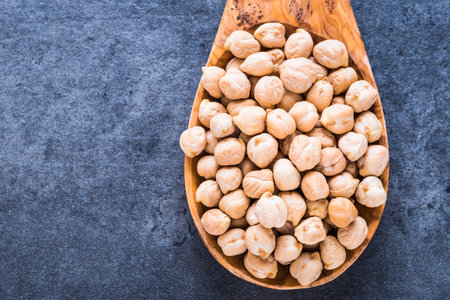 Dry chickpea top view on dark background text space.の写真素材