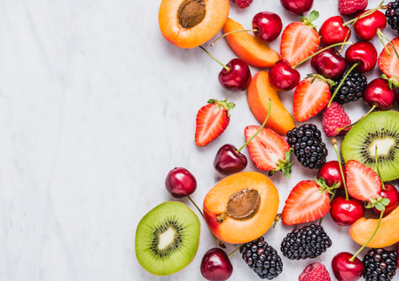 Fruits and berries copy space on white marble table.の写真素材