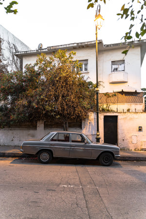 an old car parked on a street in an Arab city