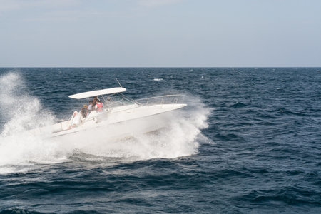 White Motor Boat Rushing Through the Waves in Indian Ocean Close to Sri Lanka Coastの写真素材