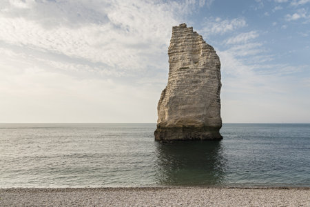 The pointed formation called LAiguille or the Needle and Porte dAval at Etretat, a commune in the Seine-Maritime department in the Normandy region of north western Franceの写真素材