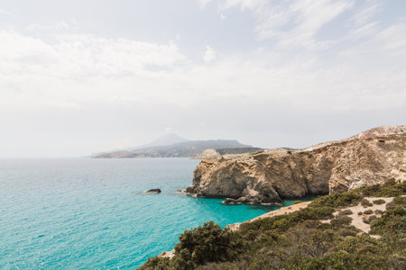 Colourful rocks of Firiplaka beach on Milos island, Greece. Sunny day, panoramic view
