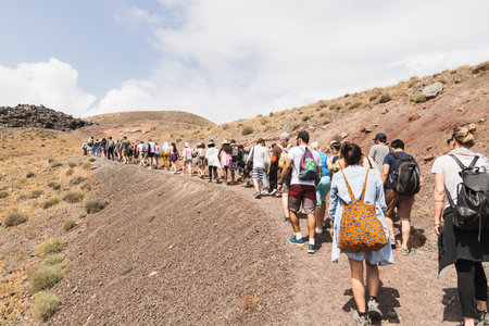 SANTORINI, GREECE - MAY 2018: Crowd of Tourists Walking up the Caldera of Volcano on Santorini...