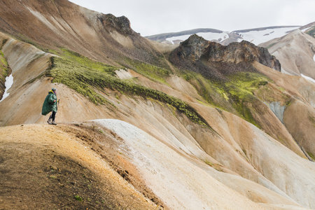 Woman hiking in the colourful mountains of Landmannalaugar national park, Iceland.の写真素材