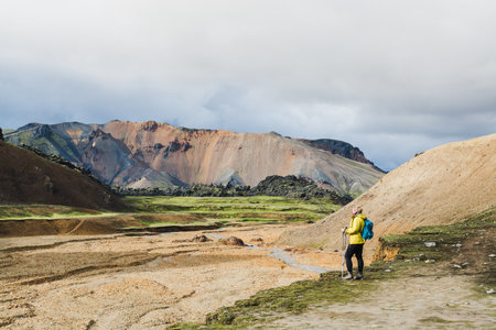 Woman hiking in the colourful mountains of Landmannalaugar national park, Iceland.の写真素材