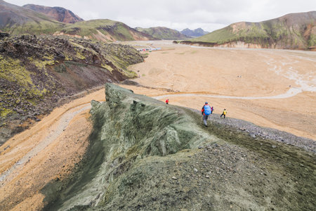 Tourists trekking in the colourful mountains of Landmannalaugar national park, Iceland.の写真素材