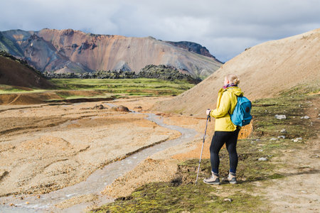 Woman hiking in the colourful mountains of Landmannalaugar national park, Iceland.の写真素材