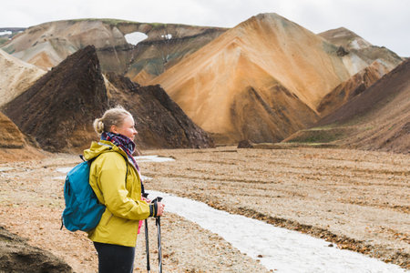 Woman hiking in the colourful mountains of Landmannalaugar national park, Iceland.の写真素材