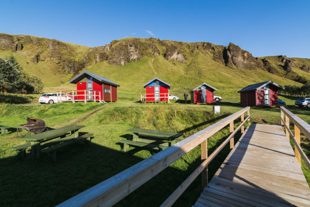 KIRKJUBAEJARKLAUSTUR, ICELAND - AUGUST 2018: Red timber cottages for rent on a campsite.のeditorial素材