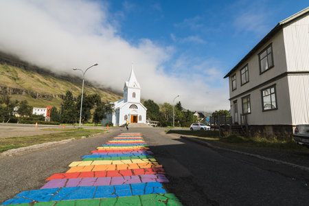 SEYDISFJORDUR, ICELAND - AUGUST 2018: wide angle lens shot of town main street with the view of Seydisfjardarkirkja.のeditorial素材