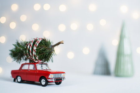 Red toy car with a christmas tree on the roofの写真素材