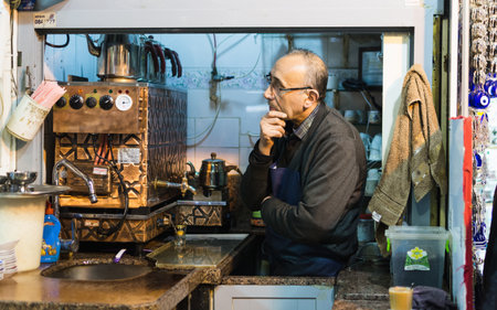 ISTANBUL, TURKEY - APRIL 2015: tea maker looking out of his kiosk at Grand Bazaar.のeditorial素材